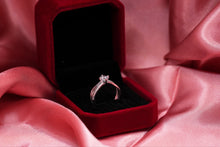 Load image into Gallery viewer, Silver diamond ring in a red box on pink fabric