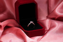 Load image into Gallery viewer, Diamond ring in a red velvet box on pink fabric