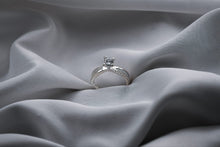 Load image into Gallery viewer, Silver ring with a diamond on gray fabric