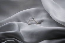 Load image into Gallery viewer, Diamond ring on a gray fabric surface