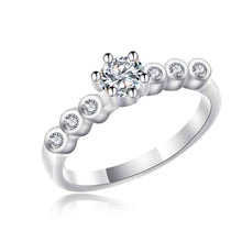 Load image into Gallery viewer, Silver ring with a central diamond and smaller diamonds on the band