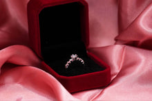 Load image into Gallery viewer, Silver ring in a red velvet box on pink fabric