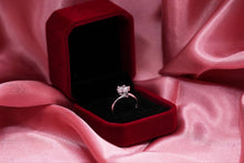 Load image into Gallery viewer, Silver ring in a red velvet box on pink fabric