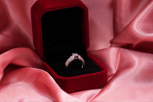 Load image into Gallery viewer, Silver diamond ring in a red velvet box on pink fabric
