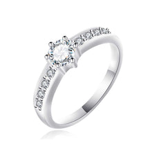 Load image into Gallery viewer, A silver engagement ring with a central zirconium diamond surrounded by smaller clear crystals on a white band.