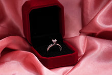 Load image into Gallery viewer, Silver diamond ring in a red velvet box on pink fabric
