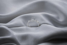 Load image into Gallery viewer, Silver diamond ring on a gray fabric surface
