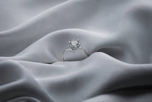 Load image into Gallery viewer, Silver ring on a gray fabric surface
