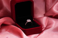 Load image into Gallery viewer, Diamond ring in a red box on pink fabric
