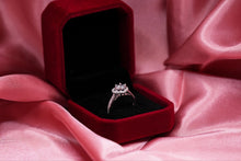 Load image into Gallery viewer, Diamond ring in a red velvet box on pink fabric

