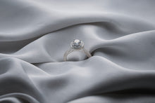 Load image into Gallery viewer, Silver diamond ring on a textured gray fabric surface
