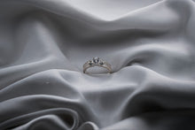 Load image into Gallery viewer, Silver ring with a diamond on a gray fabric background
