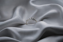 Load image into Gallery viewer, Silver ring with gemstones on a gray fabric background
